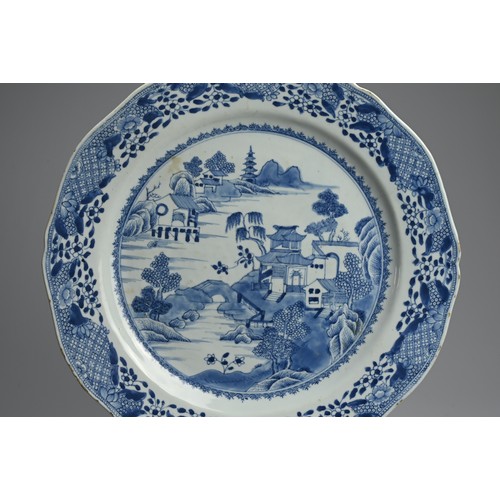 217 - A LARGE CHINESE BLUE AND WHITE PORCELAIN DISH, 18TH CENTURY. With lobed sides decorated with buildin... 