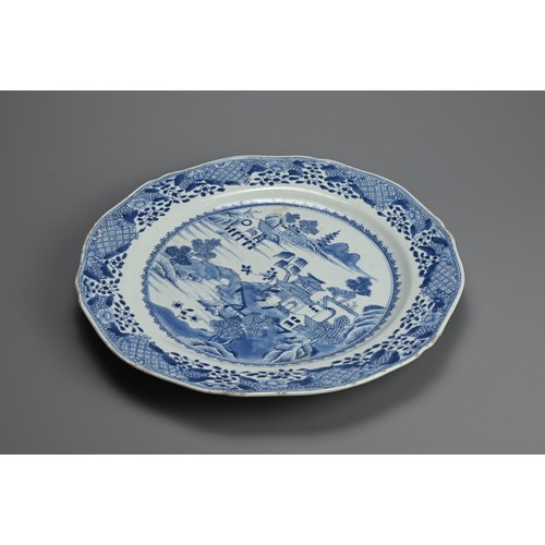 217 - A LARGE CHINESE BLUE AND WHITE PORCELAIN DISH, 18TH CENTURY. With lobed sides decorated with buildin... 