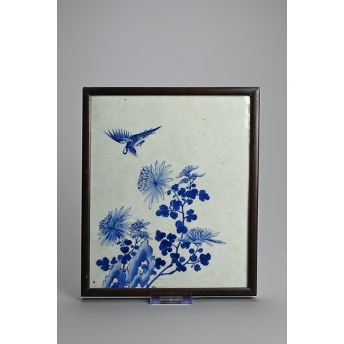 223 - A CHINESE FRAMED BLUE AND WHITE PORCELAIN TILE, 19/20TH CENTURY. Of rectangular form decorated with ... 