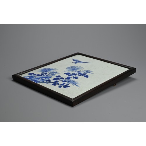 223 - A CHINESE FRAMED BLUE AND WHITE PORCELAIN TILE, 19/20TH CENTURY. Of rectangular form decorated with ... 