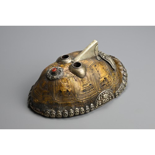 231 - A TIBETAN TURTLE SHELL KAPALA MASK, 19/20TH CENTURY. The shell mounted with white metal facial featu... 