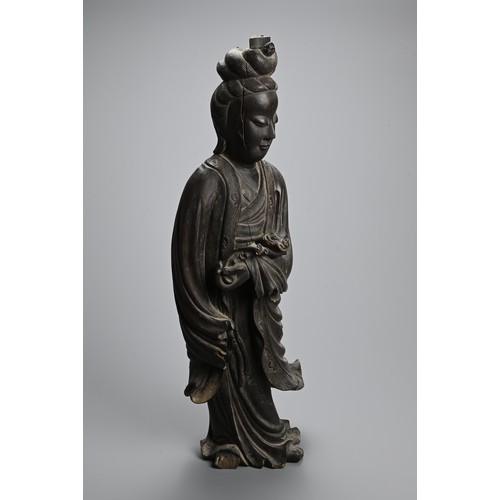 232 - A LARGE CHINESE CARVED WOODEN FIGURE OF GUANYIN, LATE 19TH CENTURY. Dressed in long flowing robes ho... 