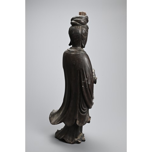 232 - A LARGE CHINESE CARVED WOODEN FIGURE OF GUANYIN, LATE 19TH CENTURY. Dressed in long flowing robes ho... 