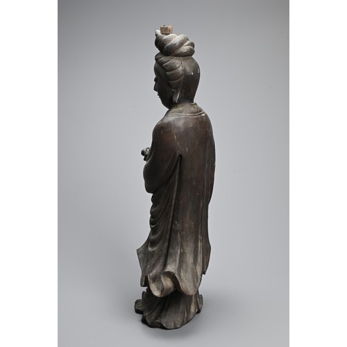 232 - A LARGE CHINESE CARVED WOODEN FIGURE OF GUANYIN, LATE 19TH CENTURY. Dressed in long flowing robes ho... 