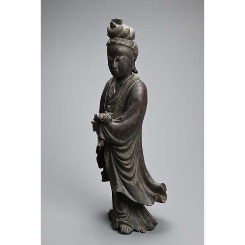 232 - A LARGE CHINESE CARVED WOODEN FIGURE OF GUANYIN, LATE 19TH CENTURY. Dressed in long flowing robes ho... 