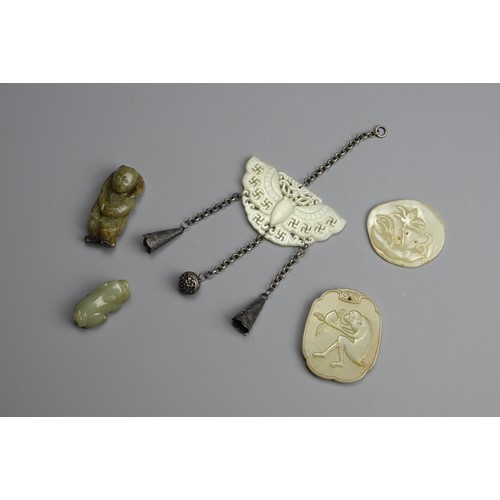 235 - A GROUP OF CHINESE CELADON JADE ITEMS. To include a carved and pierced butterfly pendant with Buddhi... 