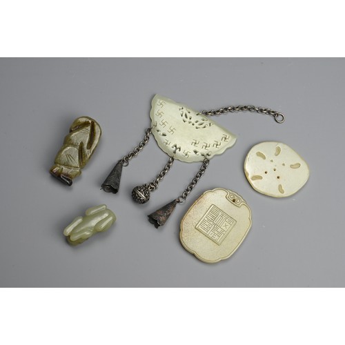 235 - A GROUP OF CHINESE CELADON JADE ITEMS. To include a carved and pierced butterfly pendant with Buddhi... 