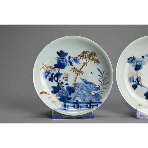 239 - THREE CHINESE BLUE AND WHITE GILT DECORATED SAUCERS, 18TH CENTURY. Each featuring a bird on rockwork... 