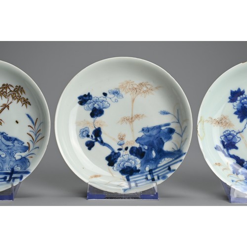 239 - THREE CHINESE BLUE AND WHITE GILT DECORATED SAUCERS, 18TH CENTURY. Each featuring a bird on rockwork... 