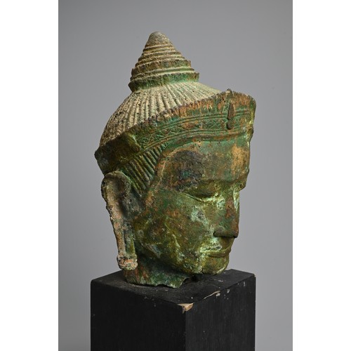 246 - A SOUTHEAST ASIAN CAST BRONZE HEAD OF A MALE DEITY. Probably Cambodian, wearing a headdress with pen... 