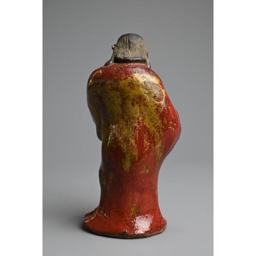 249 - A CHINESE GLAZED SHIWAN POTTERY MODEL OF DAMO, 19/20TH CENTURY. Standing bare foot dressed in robe, ... 