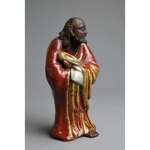 249 - A CHINESE GLAZED SHIWAN POTTERY MODEL OF DAMO, 19/20TH CENTURY. Standing bare foot dressed in robe, ... 