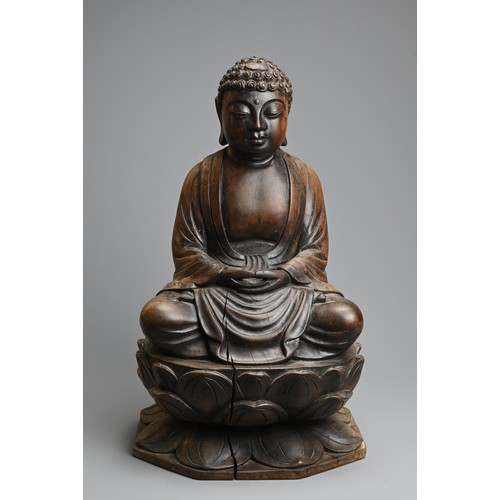 254 - A CARVED WOODEN FIGURE OF BUDDHA, 20TH CENTURY. Dressed in robes seated on a lotus base. 40.5cm tall... 