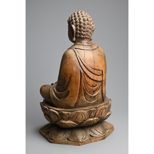 254 - A CARVED WOODEN FIGURE OF BUDDHA, 20TH CENTURY. Dressed in robes seated on a lotus base. 40.5cm tall... 