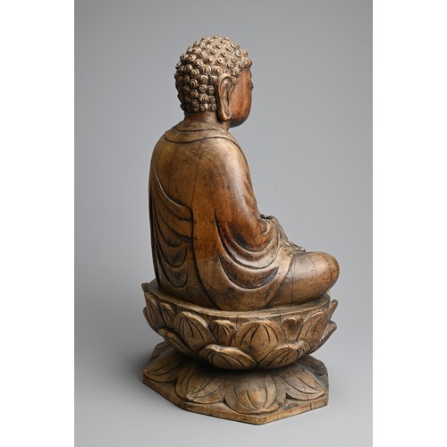 254 - A CARVED WOODEN FIGURE OF BUDDHA, 20TH CENTURY. Dressed in robes seated on a lotus base. 40.5cm tall... 