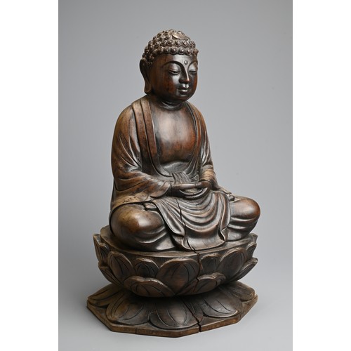 254 - A CARVED WOODEN FIGURE OF BUDDHA, 20TH CENTURY. Dressed in robes seated on a lotus base. 40.5cm tall... 