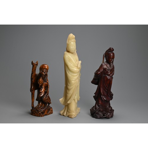 256 - THREE CHINESE CARVED WOOD AND SOAPSTONE FIGURES, 20TH CENTURY. To include a carved jade figure of st... 