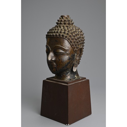 258 - A THAI BRONZE HEAD OF BUDDHA, 18TH CENTURY. Heavily cast with downcast eyes and serene expression. M... 