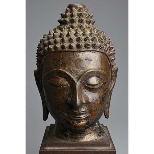 258 - A THAI BRONZE HEAD OF BUDDHA, 18TH CENTURY. Heavily cast with downcast eyes and serene expression. M... 