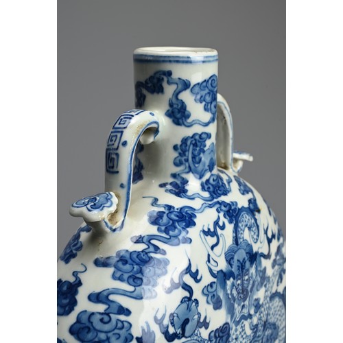 313 - A CHINESE BLUE AND WHITE PORCELAIN MOONFLASK, QIANLONG MARK. With curved ruyi handles decorated with... 