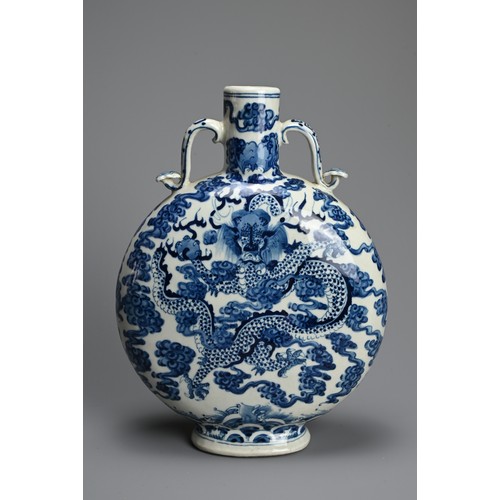 312 - A CHINESE BLUE AND WHITE PORCELAIN MOONFLASK, KANGXI MARK. With curved ruyi handles decorated with d... 