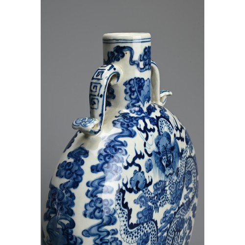 312 - A CHINESE BLUE AND WHITE PORCELAIN MOONFLASK, KANGXI MARK. With curved ruyi handles decorated with d... 