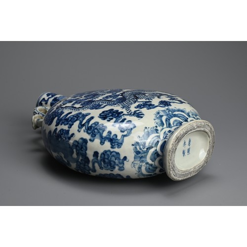 312 - A CHINESE BLUE AND WHITE PORCELAIN MOONFLASK, KANGXI MARK. With curved ruyi handles decorated with d... 