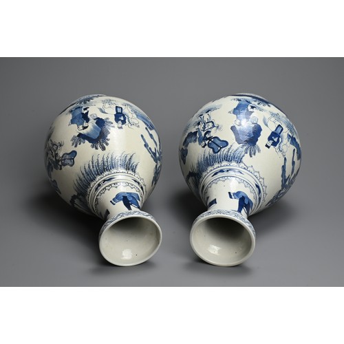 311 - A LARGE NEAR PAIR OF CHINESE BLUE AND WHITE PORCELAIN VASES, 20TH CENTURY. Of pear shape on a tall s... 