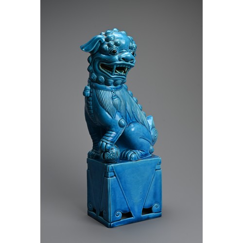 317 - A LARGE CHINESE TURQUOISE GLAZED PORCELAIN FOO DOG, 20TH CENTURY. Seated on a square form stand with... 