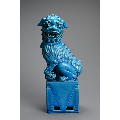 317 - A LARGE CHINESE TURQUOISE GLAZED PORCELAIN FOO DOG, 20TH CENTURY. Seated on a square form stand with... 