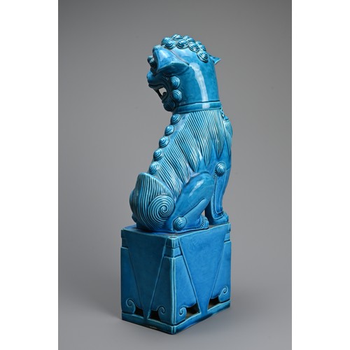 317 - A LARGE CHINESE TURQUOISE GLAZED PORCELAIN FOO DOG, 20TH CENTURY. Seated on a square form stand with... 