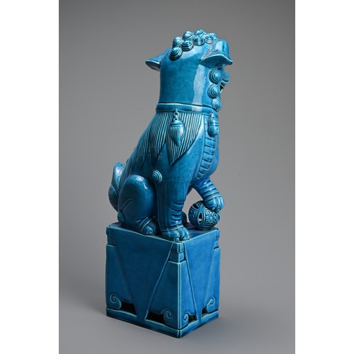 317 - A LARGE CHINESE TURQUOISE GLAZED PORCELAIN FOO DOG, 20TH CENTURY. Seated on a square form stand with... 