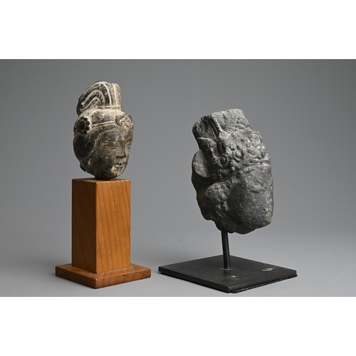 261 - TWO CHINESE CARVED GREY STONE HEADS OF GUANYIN. Each with headdress mounted on later display stands.... 