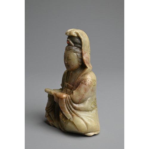 262 - A CHINESE CARVED SOAPSTONE FIGURE OF GUANYIN, 19/20TH CENTURY. The figure seated dressed in robes in... 