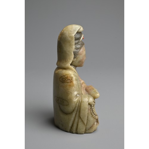 262 - A CHINESE CARVED SOAPSTONE FIGURE OF GUANYIN, 19/20TH CENTURY. The figure seated dressed in robes in... 