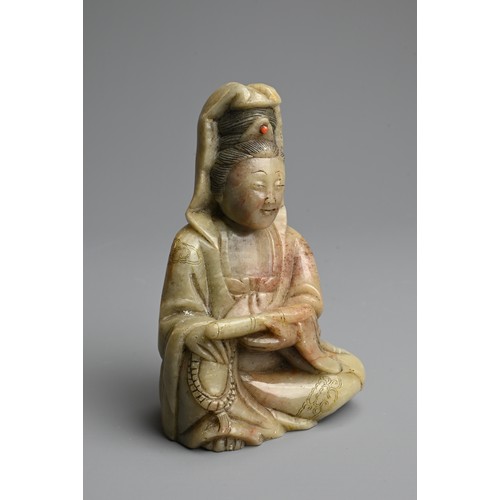 262 - A CHINESE CARVED SOAPSTONE FIGURE OF GUANYIN, 19/20TH CENTURY. The figure seated dressed in robes in... 