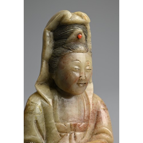 262 - A CHINESE CARVED SOAPSTONE FIGURE OF GUANYIN, 19/20TH CENTURY. The figure seated dressed in robes in... 