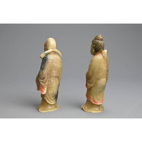 263 - A PAIR OF PAINTED SOAPSTONE FIGURES OF IMMORTALS, 19/20TH CENTURY. Each stood dress in robes with in... 