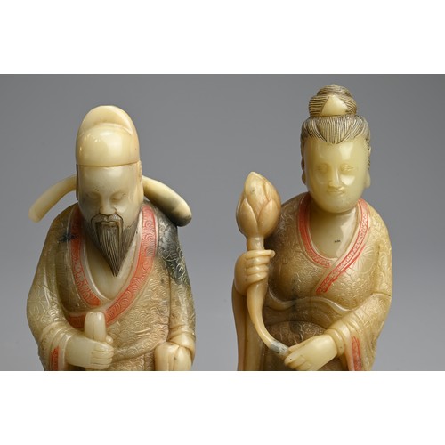 263 - A PAIR OF PAINTED SOAPSTONE FIGURES OF IMMORTALS, 19/20TH CENTURY. Each stood dress in robes with in... 