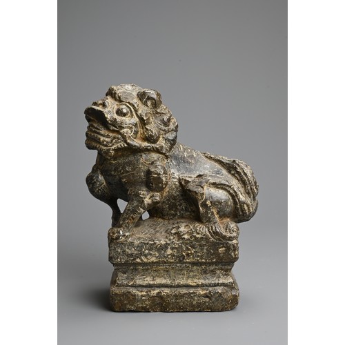 265 - A CHINESE CARVED GREY STONE MODEL OF A GUARDIAN LION, MING DYNASTY. The lion seated on a raised pede... 