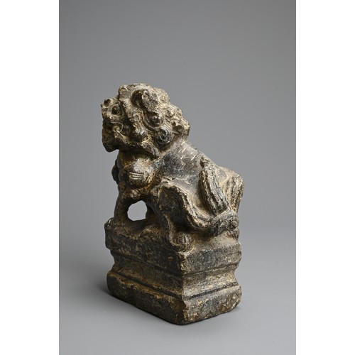 265 - A CHINESE CARVED GREY STONE MODEL OF A GUARDIAN LION, MING DYNASTY. The lion seated on a raised pede... 