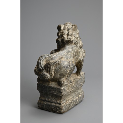 265 - A CHINESE CARVED GREY STONE MODEL OF A GUARDIAN LION, MING DYNASTY. The lion seated on a raised pede... 