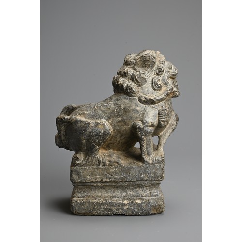 265 - A CHINESE CARVED GREY STONE MODEL OF A GUARDIAN LION, MING DYNASTY. The lion seated on a raised pede... 