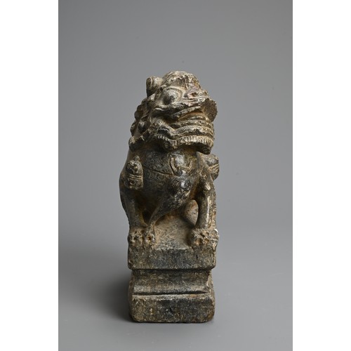 265 - A CHINESE CARVED GREY STONE MODEL OF A GUARDIAN LION, MING DYNASTY. The lion seated on a raised pede... 