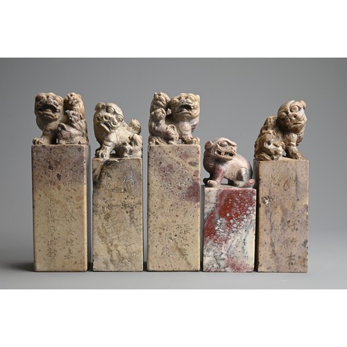 267 - A GROUP OF CHINESE CARVED SOAPSTONE SEALS, 20TH CENTURY. Each of tall square form surmounted by lion... 