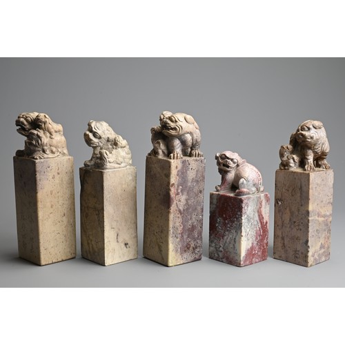 267 - A GROUP OF CHINESE CARVED SOAPSTONE SEALS, 20TH CENTURY. Each of tall square form surmounted by lion... 