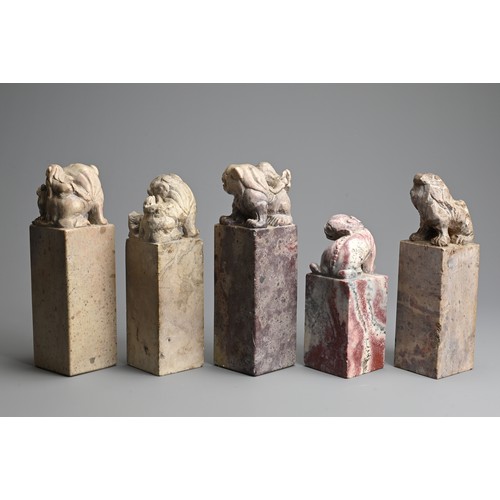 267 - A GROUP OF CHINESE CARVED SOAPSTONE SEALS, 20TH CENTURY. Each of tall square form surmounted by lion... 