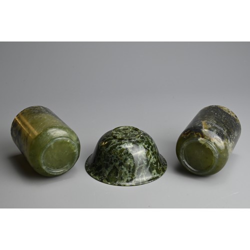 270 - THREE CHINESE SPINACH JADE CUPS AND BOWL, 20TH CENTURY. Dark green and black mottled jade carved int... 