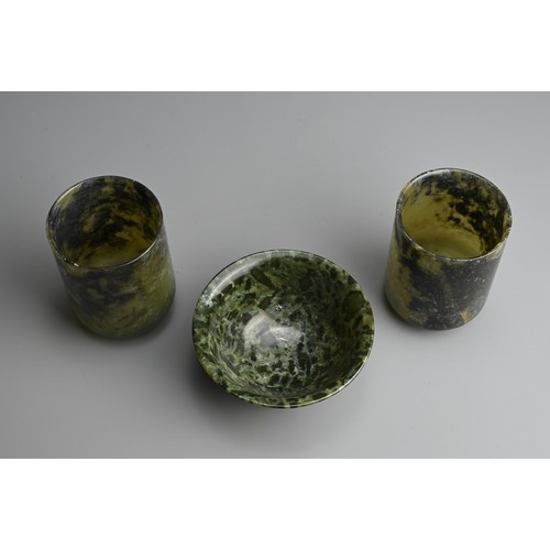 270 - THREE CHINESE SPINACH JADE CUPS AND BOWL, 20TH CENTURY. Dark green and black mottled jade carved int... 