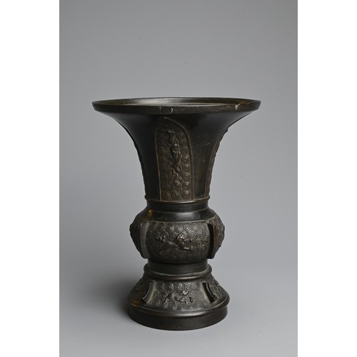 273 - A CHINESE BRONZE GU VASE, QING DYNASTY. With wide flared mouth decorated to the foot and mid section... 